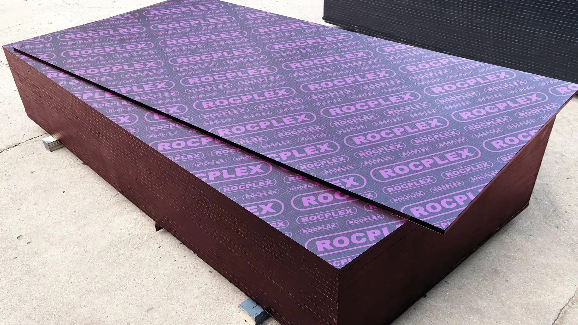 ROCPLEX film faced plywood sheets stacked for concrete formwork with sealed edges